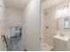 Hallway view to kitchen and bathroom with new tile and updated fixtures at 8483 Magnolia Dr, Jonesboro, GA 30238