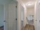 Hallway features updated flooring and ample doorway access to the surrounding living spaces at 8483 Magnolia Dr, Jonesboro, GA 30238