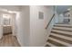 Hallway with view of stairs, bathroom, and kitchen with gray cabinets at 8483 Magnolia Dr, Jonesboro, GA 30238