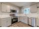 Updated kitchen featuring stainless steel appliances, gray cabinetry, and modern finishes at 8483 Magnolia Dr, Jonesboro, GA 30238