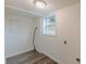 A minimalist laundry room featuring hookups and wood-look flooring at 8483 Magnolia Dr, Jonesboro, GA 30238