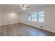 Bright living room with freshly painted walls, modern flooring, and large windows at 8483 Magnolia Dr, Jonesboro, GA 30238