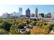 A home surrounded by trees with an Atlanta skyline in the distance at 115 17Th Ne St, Atlanta, GA 30309