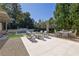 Gorgeous backyard offers outdoor seating, an outdoor kitchen, swimming pool, and meticulous landscaping at 115 17Th Ne St, Atlanta, GA 30309