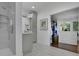 Bright bathroom featuring a modern glass shower and access to a walk-in closet at 115 17Th Ne St, Atlanta, GA 30309