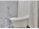 Elegant bathroom features a freestanding tub with stylish fixtures and a shower curtain at 115 17Th Ne St, Atlanta, GA 30309