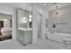 Bright bathroom featuring a modern soaking tub, glass shower, and a walk-in closet at 115 17Th Ne St, Atlanta, GA 30309