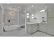 Bright bathroom featuring a modern soaking tub, glass shower, and white marble tile at 115 17Th Ne St, Atlanta, GA 30309