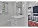 This bright bathroom showcases a white vanity with modern fixtures and a view to the bedroom at 115 17Th Ne St, Atlanta, GA 30309