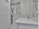 Well-lit bathroom featuring a white vanity, ample storage, and a view to the natural light at 115 17Th Ne St, Atlanta, GA 30309