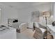 Bright bedroom features a black and white striped bedspread, a wicker chair and white walls at 115 17Th Ne St, Atlanta, GA 30309