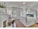 Relaxing bedroom featuring a fireplace, canopy bed, and natural light at 115 17Th Ne St, Atlanta, GA 30309
