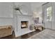 Bedroom view showcasing a fireplace, wing chair, and natural light at 115 17Th Ne St, Atlanta, GA 30309