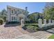 Stately two-story home boasts a manicured lawn, brick driveway and wrought iron fence at 115 17Th Ne St, Atlanta, GA 30309