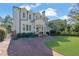 Elegant two-story home with a brick driveway, manicured landscaping, and charming front porch at 115 17Th Ne St, Atlanta, GA 30309