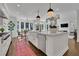 Gourmet kitchen with a large center island, farmhouse sink, and adjacent casual dining area with outdoor views at 115 17Th Ne St, Atlanta, GA 30309