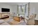 Cozy living room featuring hardwood floors, bay window, and neutral decor at 115 17Th Ne St, Atlanta, GA 30309