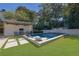 Inviting pool offers sun loungers, a seating area with an outdoor kitchen, lush grass and landscaping at 115 17Th Ne St, Atlanta, GA 30309