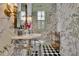 Elegant powder room features designer wallpaper, marble sink, and stylish fixtures at 115 17Th Ne St, Atlanta, GA 30309