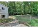Fenced backyard with green grass and mature trees with a home to the left at 4253 Smithsonia Dr, Tucker, GA 30084