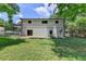 Large green backyard with a white home and some trees at 4253 Smithsonia Dr, Tucker, GA 30084
