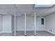 Unfinished basement with support pillars and painted white walls at 4253 Smithsonia Dr, Tucker, GA 30084