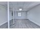 Bright basement with gray wood flooring and white support beams at 4253 Smithsonia Dr, Tucker, GA 30084