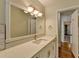 Well-lit bathroom featuring a quartz countertop, large mirror, and white cabinets at 4253 Smithsonia Dr, Tucker, GA 30084
