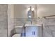 Bathroom with white marble and vanity, including a modern mirror, toilet, sink and towel bar at 4253 Smithsonia Dr, Tucker, GA 30084