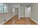 Bedroom featuring hardwood floors, mirrored closet, natural light, and white trim and doors at 4253 Smithsonia Dr, Tucker, GA 30084