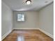 Empty bedroom with hardwood floors and a window view of the outdoors at 4253 Smithsonia Dr, Tucker, GA 30084