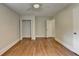 Well-lit bedroom featuring hardwood floors, a ceiling fan, a closet, and white doors and trim at 4253 Smithsonia Dr, Tucker, GA 30084