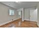 Bedroom with hardwood floors, closet with mirrored doors, window for natural light, and white trim at 4253 Smithsonia Dr, Tucker, GA 30084