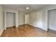 Bedroom with hardwood floors, closets, and white trim, providing a neutral palette for personalization at 4253 Smithsonia Dr, Tucker, GA 30084