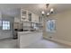 Bright eat-in kitchen featuring stainless appliances, white cabinets and large center island with cooktop at 4253 Smithsonia Dr, Tucker, GA 30084
