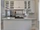 Modern eat-in kitchen featuring stainless steel appliances, white cabinets, and a breakfast bar at 4253 Smithsonia Dr, Tucker, GA 30084