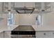 Modern kitchen featuring stainless steel appliances, white cabinets, and a sleek cooktop at 4253 Smithsonia Dr, Tucker, GA 30084
