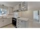 Bright kitchen featuring stainless appliances, white cabinets, and a breakfast bar that opens to dining area at 4253 Smithsonia Dr, Tucker, GA 30084