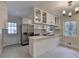 Bright eat-in kitchen featuring stainless appliances, white cabinets and large center island with cooktop at 4253 Smithsonia Dr, Tucker, GA 30084