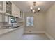 Spacious kitchen featuring white cabinets, stainless appliances, stone countertops, and stylish lighting at 4253 Smithsonia Dr, Tucker, GA 30084