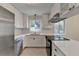 Modern kitchen featuring stainless steel appliances, white cabinets, and sleek countertops at 4253 Smithsonia Dr, Tucker, GA 30084