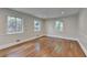 Empty room with hardwood flooring, featuring trim work and natural light from the windows at 4253 Smithsonia Dr, Tucker, GA 30084