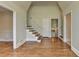 Spacious living room featuring hardwood floors, a staircase, and multiple entryways at 4253 Smithsonia Dr, Tucker, GA 30084