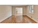Bright living room featuring hardwood floors, white trim, and an open layout to other living spaces at 4253 Smithsonia Dr, Tucker, GA 30084