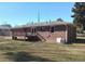 A full view of the home's backyard featuring a wooden deck and brick exterior at 6258 Mount Zion Blvd, Morrow, GA 30260