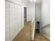 Hallway with carpeting leading to a staircase and several doors at 6420 Wedgeview Dr, Tucker, GA 30084