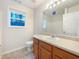 Bathroom with wood cabinets, large mirror, and tub and shower combo at 781 Courthouse Park Dr, Temple, GA 30179