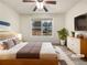 Staged bedroom with neutral tones, a queen bed, and a large window at 781 Courthouse Park Dr, Temple, GA 30179