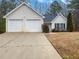 Charming home with two-car garage, vinyl siding, and well-maintained lawn at 781 Courthouse Park Dr, Temple, GA 30179