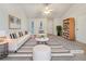 Staged living room with modern decor, vaulted ceiling, and lots of natural light at 781 Courthouse Park Dr, Temple, GA 30179